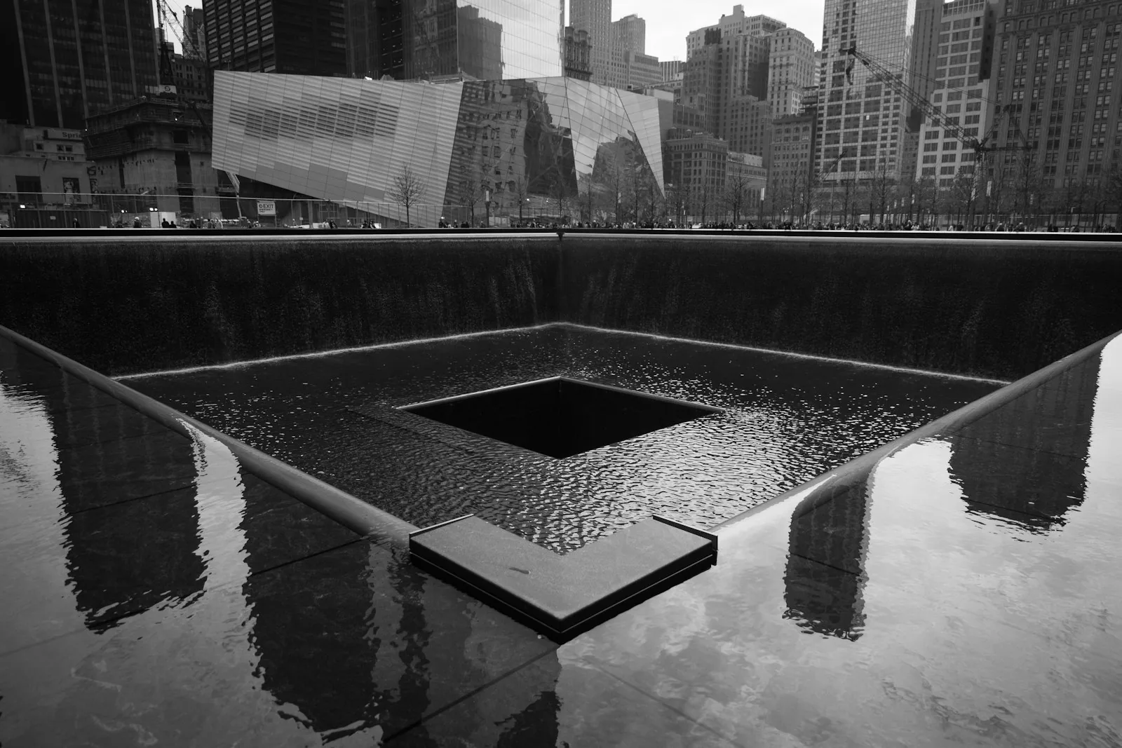 Twin reflecting pools at the 9/11 Memorial in New York City with waterfalls and names inscribed in bronze