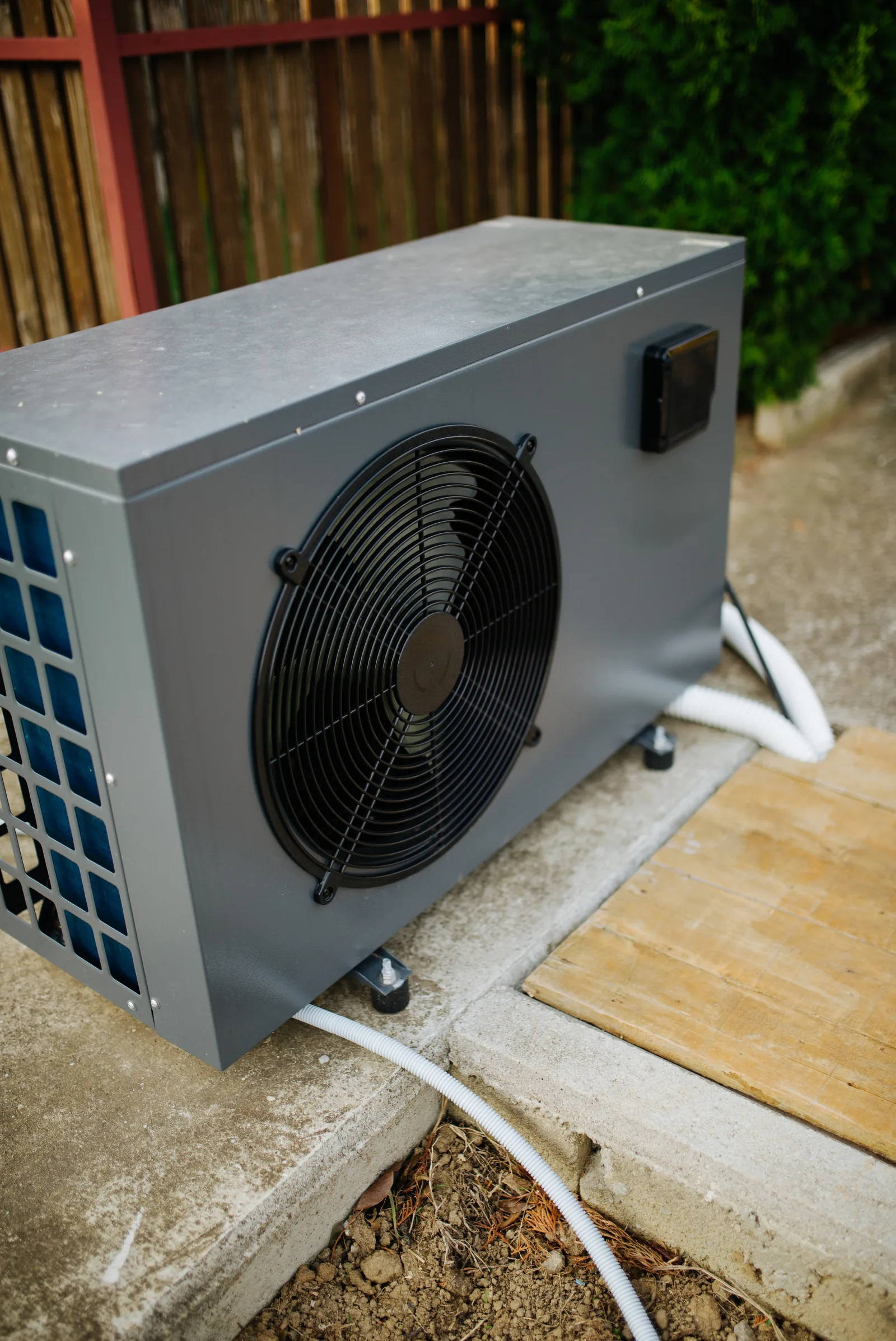 Outdoor air source heat pump unit connected with pipes for swimming pool heating representing the most cost-effective heating option
