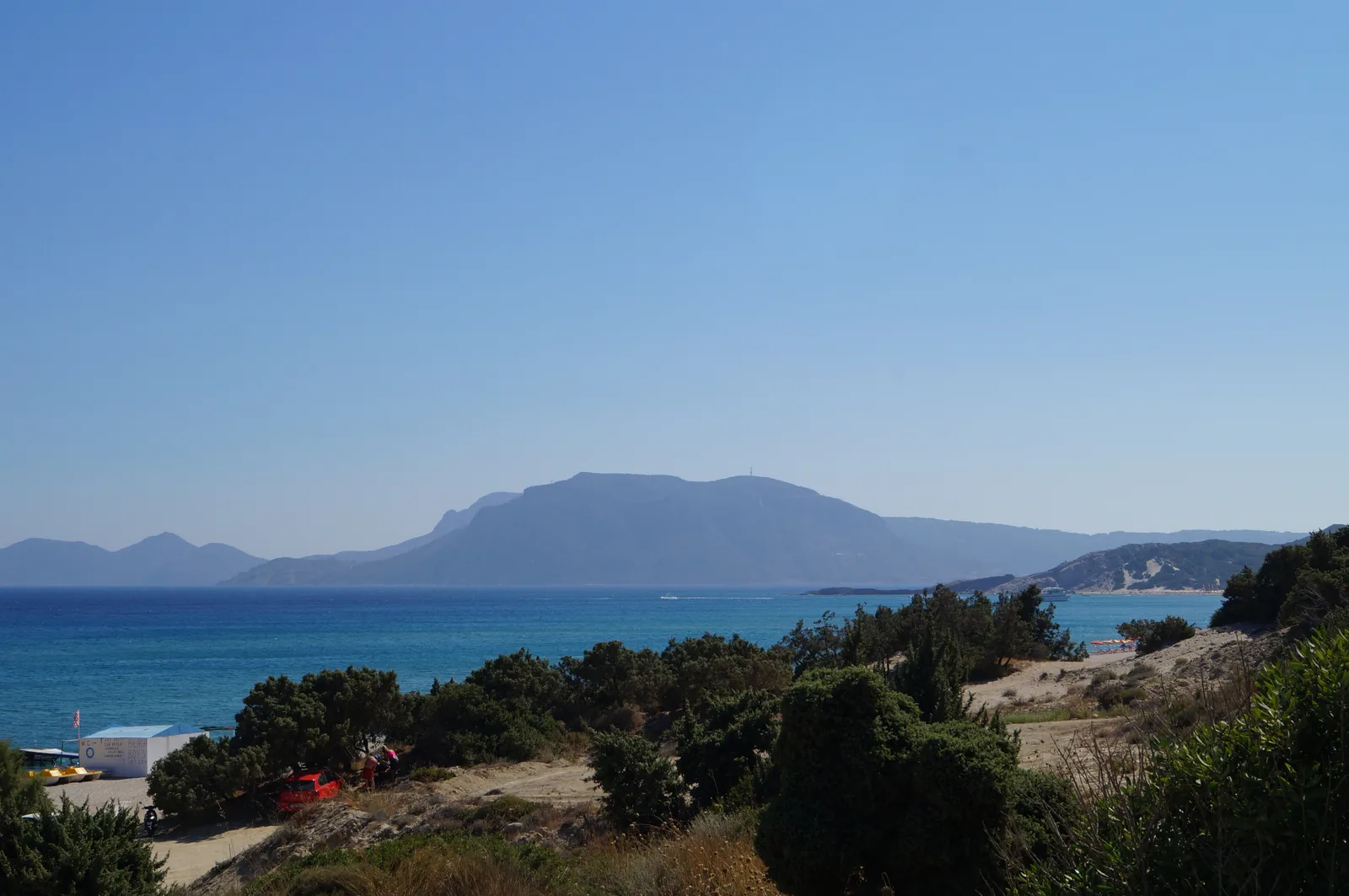 Kefalos Bay on Kos island showing turquoise Aegean sea with mountains behind — one of Greece's main all-inclusive holiday islands