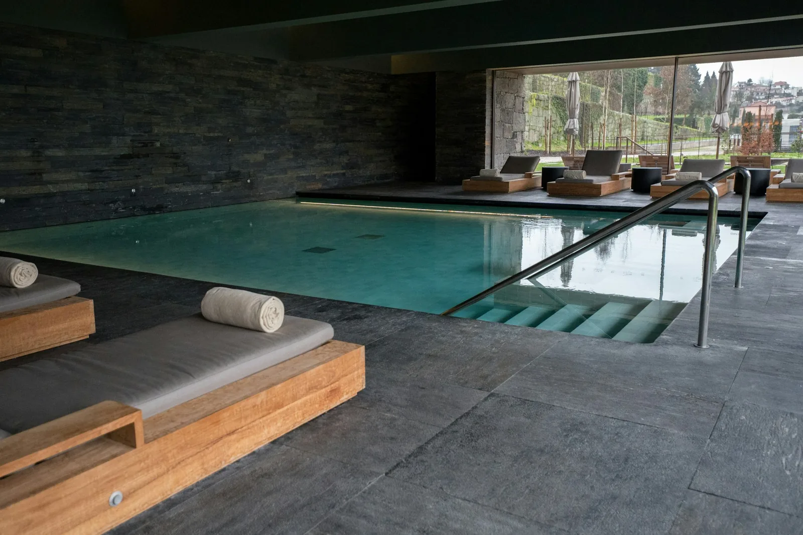 Indoor luxury spa pool with loungers representing Birmingham's premium pool and spa facilities