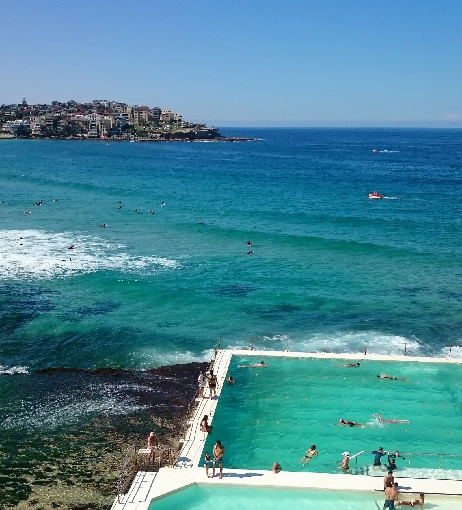 Bondi Icebergs ocean pool with swimmers, waves and Ben Buckler headland in the background