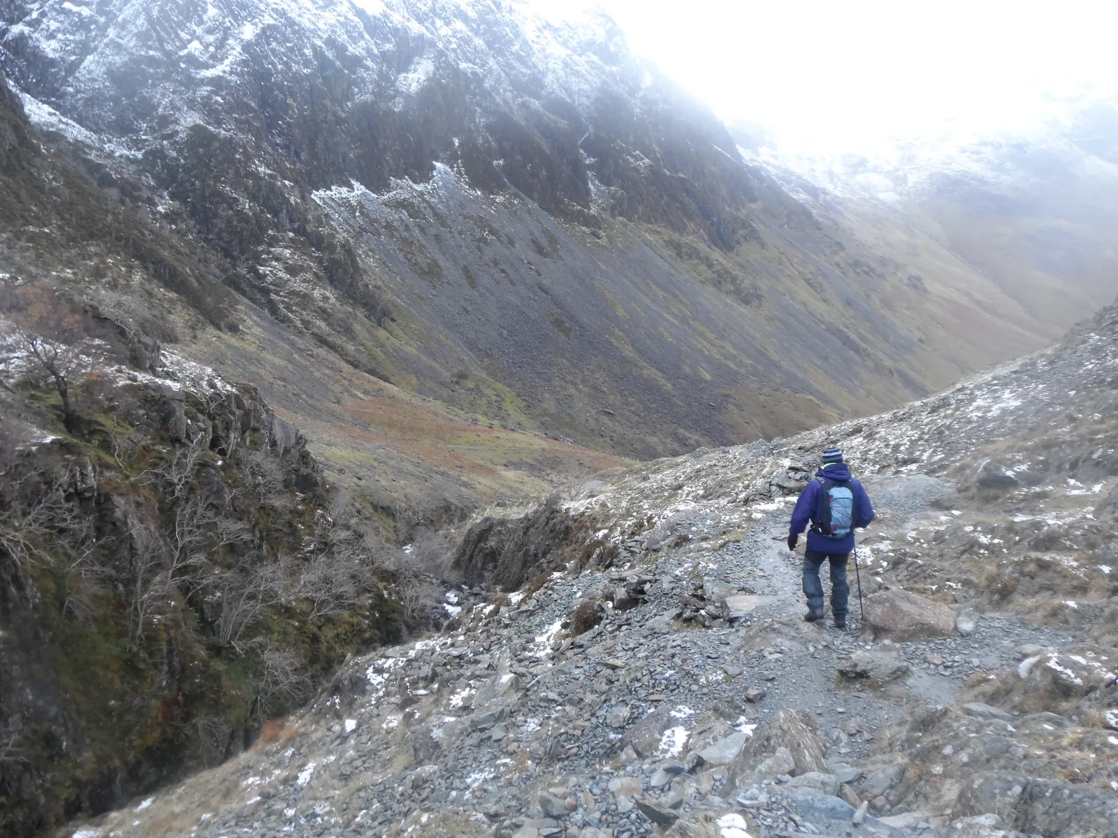 Walker on a rocky fell path beside Warnscale Beck on the route to the Buttermere Infinity Pool
