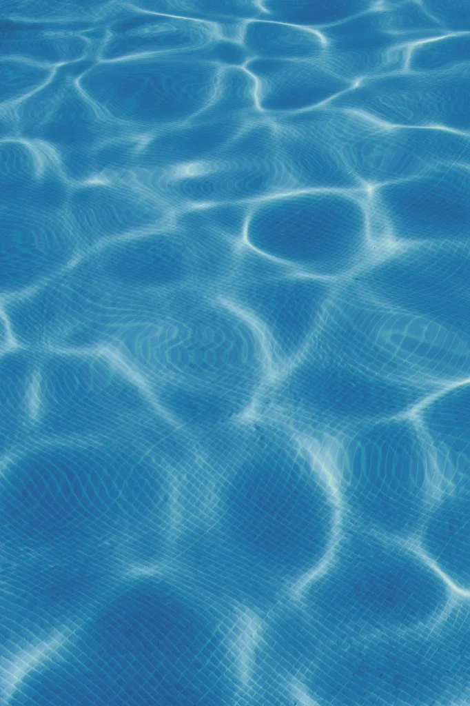 Clear blue swimming pool water with light ripples, symbolising the emotional subconscious in pool dreams