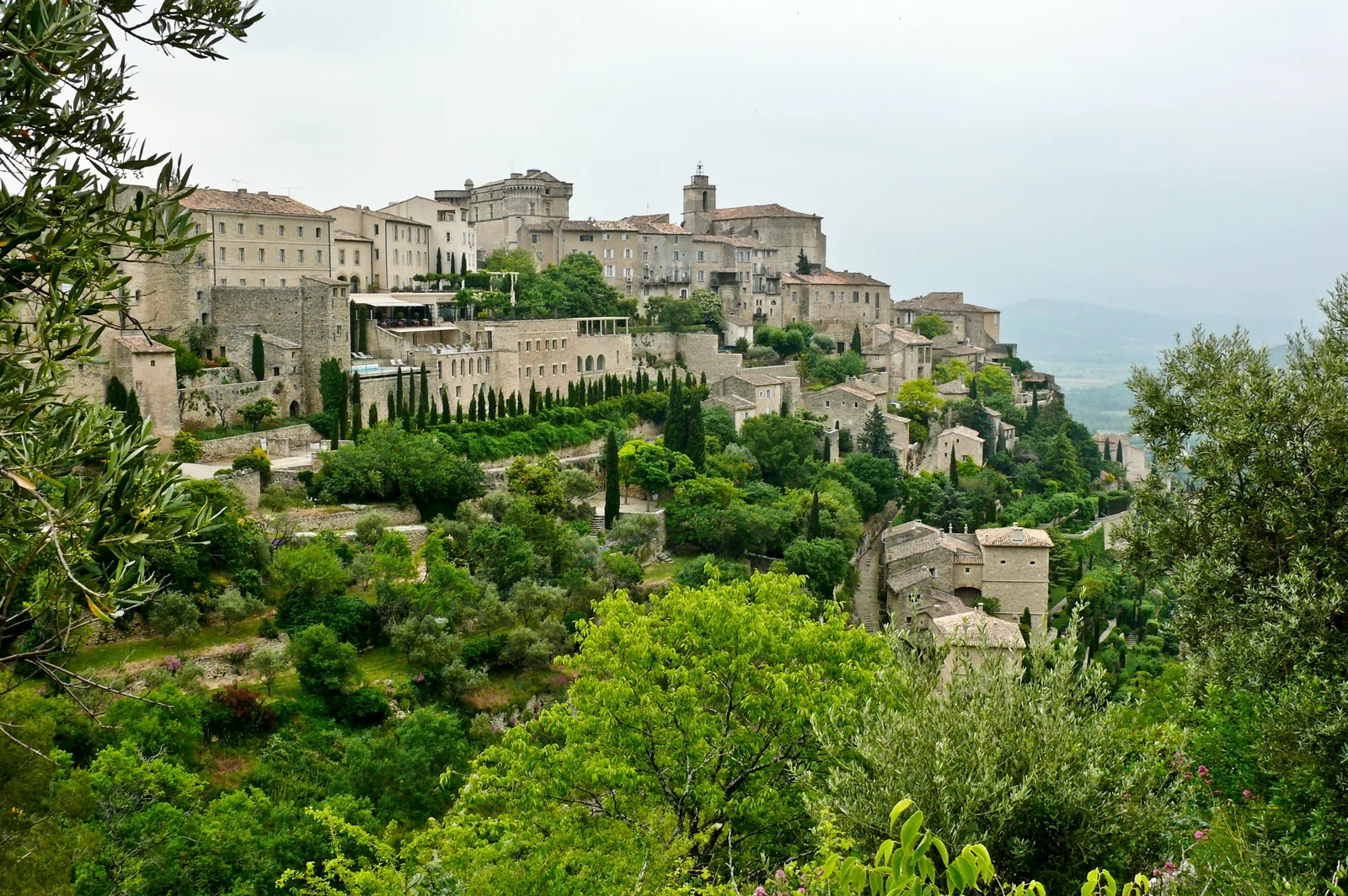 The hilltop village of Gordes in the Luberon, Provence, with stone buildings and olive trees representing the Provence villa rental region