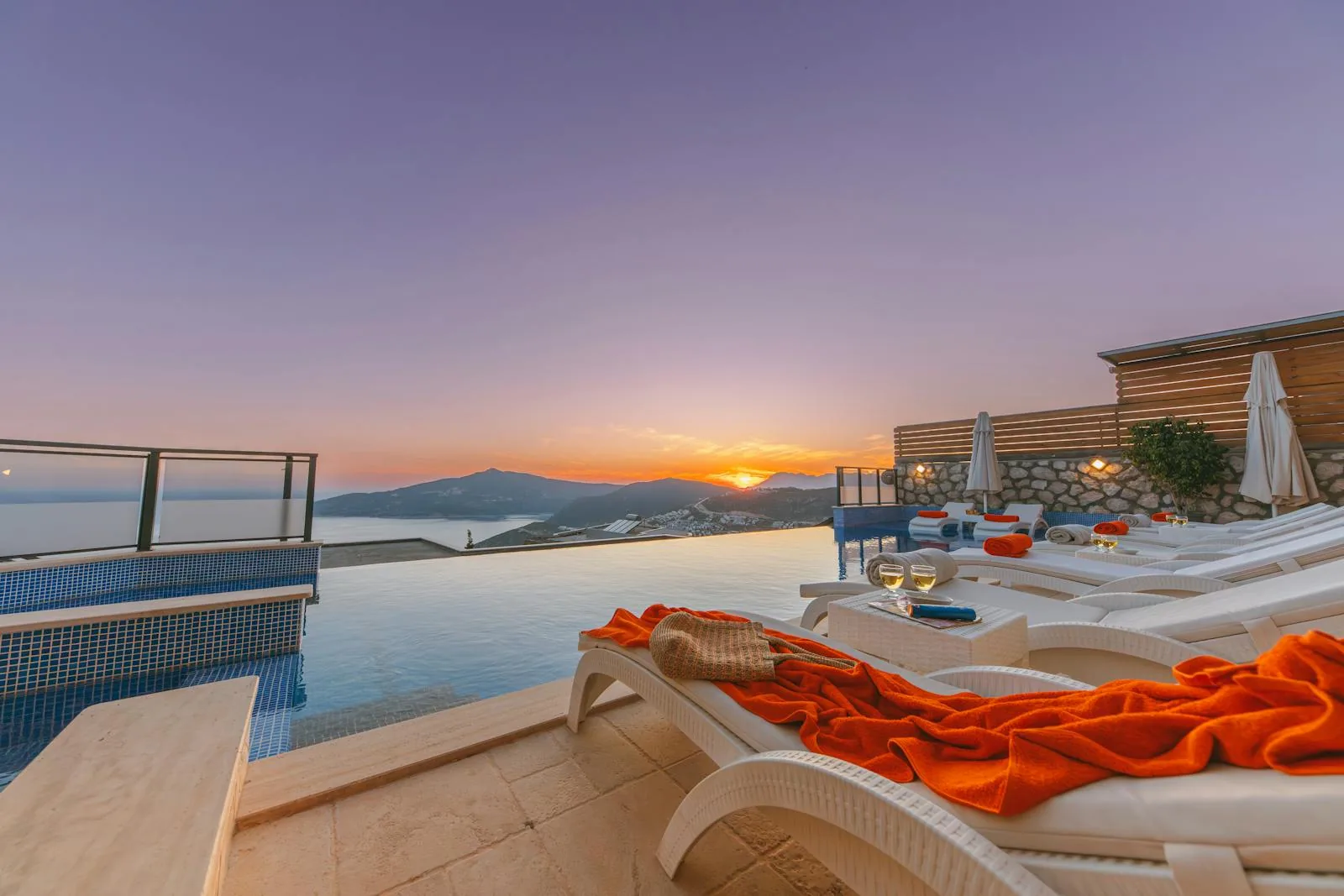 A private swimming pool and sun terrace at a luxury villa holiday property in Greece with views across the Aegean Sea under a clear blue Mediterranean sky representing villa pool holidays on Crete Rhodes and the Aegean islands