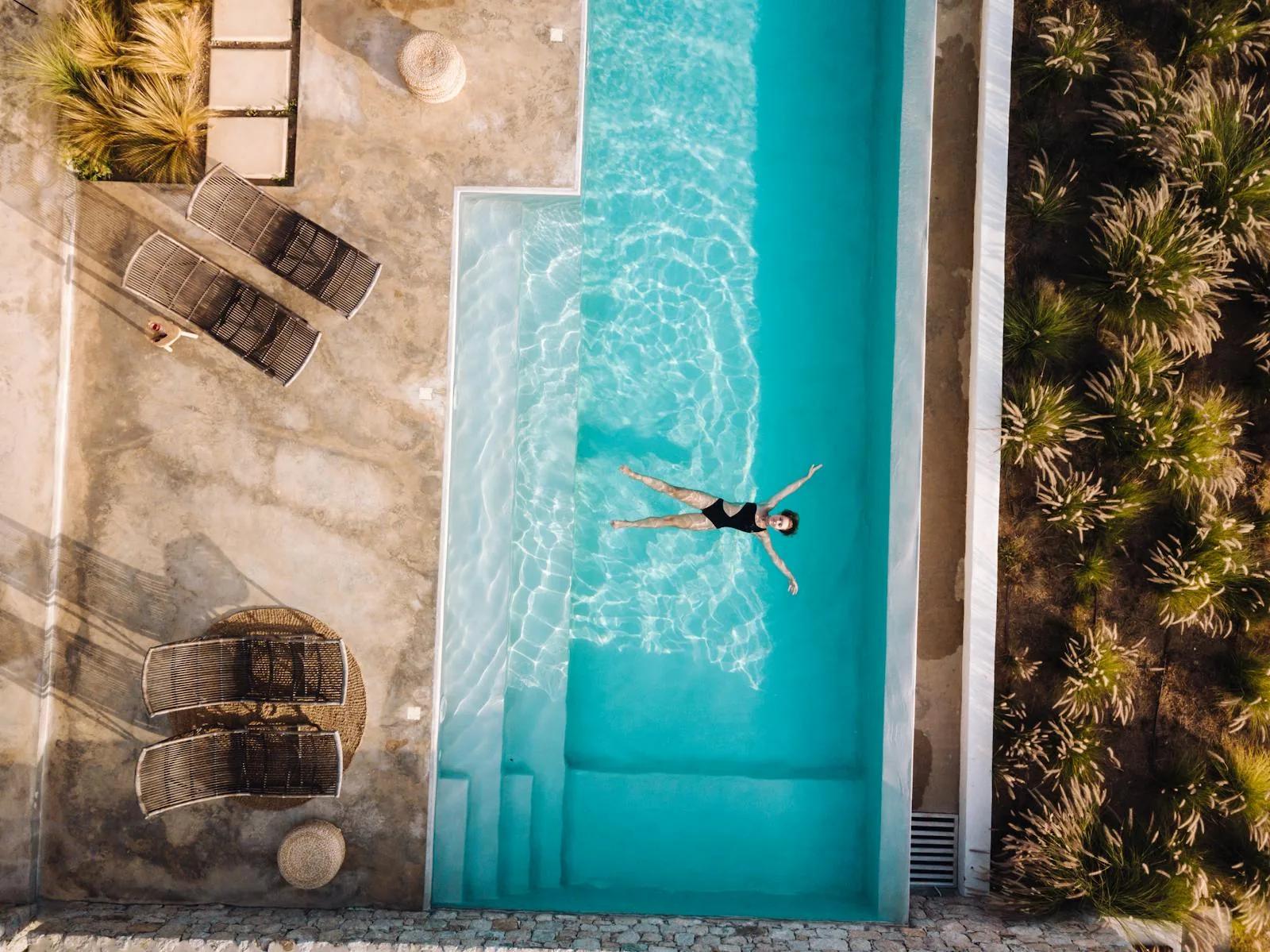 A swim-up pool room at a Greek island resort hotel with direct terrace access to a turquoise pool and sun loungers under bright Mediterranean sunshine representing swim-up room hotels in Rhodes Crete and Kos