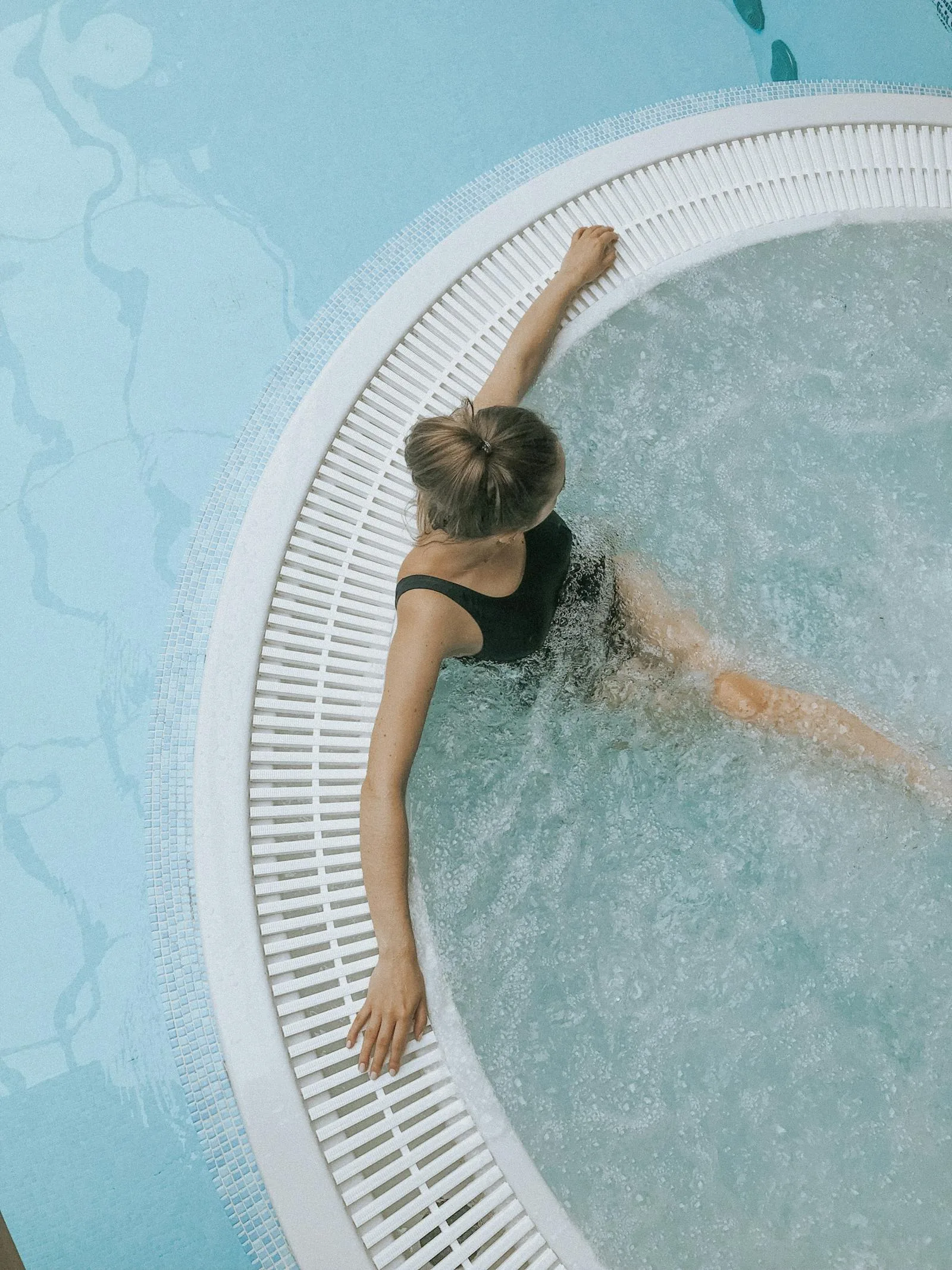 Guest relaxing in a warm hydrotherapy spa pool with bubbling jets at a UK hotel