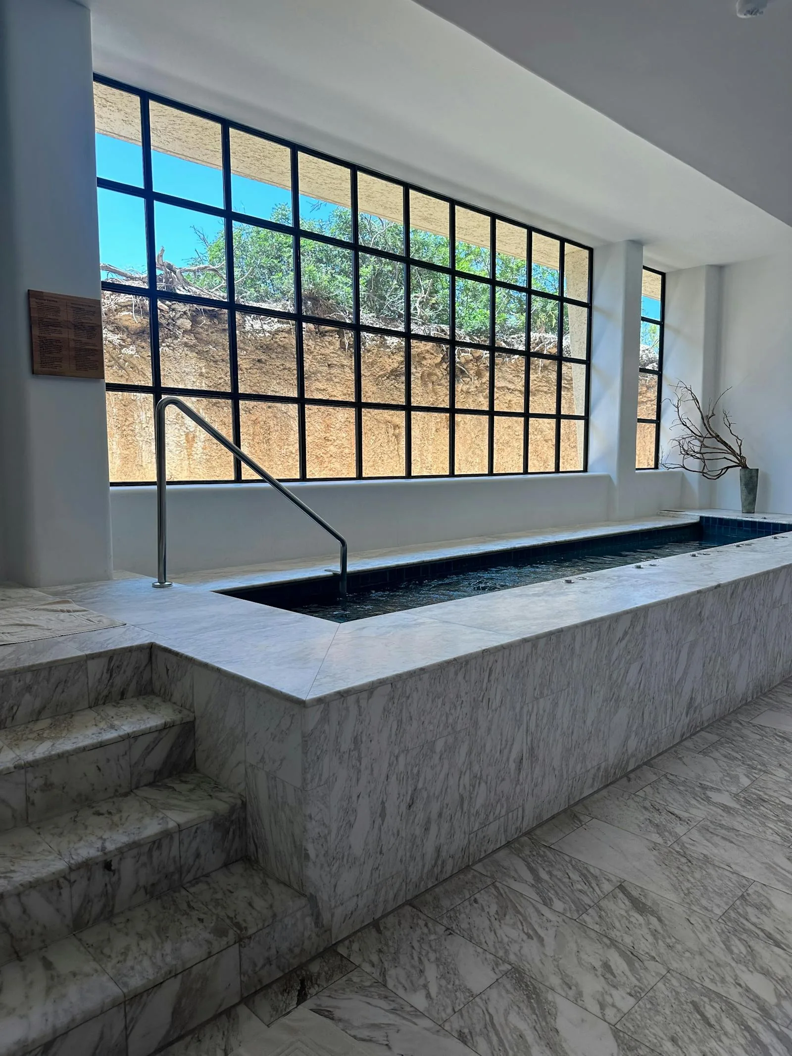 Luxury marble indoor swimming pool with large windows at a UK country house hotel