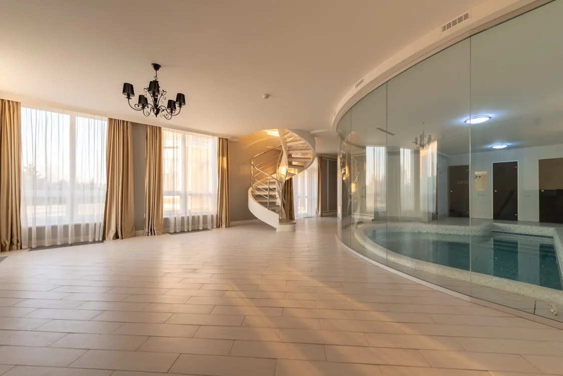 Luxury residential indoor swimming pool in a UK house with glass walls and modern architecture