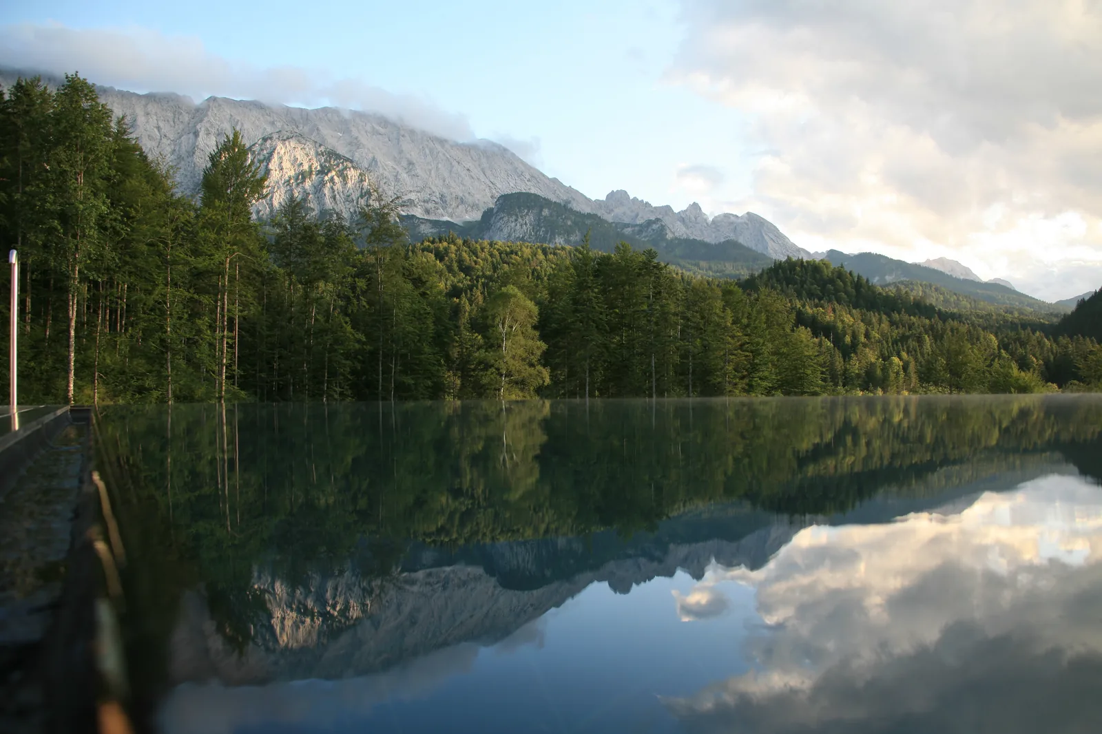 Schloss Elmau rooftop infinity pool reflecting the Bavarian Alps in Germany