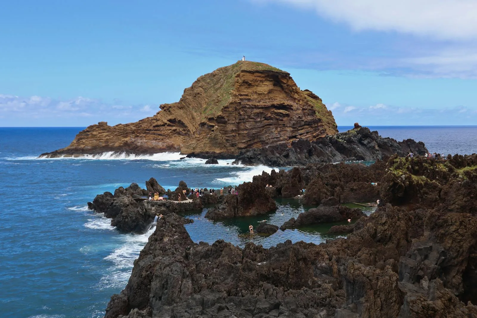 Natural volcanic rock pools at Porto Moniz Madeira with black basalt formations and turquoise Atlantic seawater