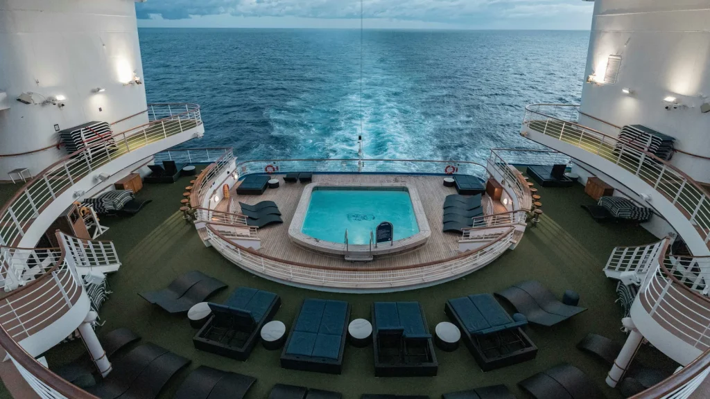 MSC Virtuosa aft pool deck with sun loungers and ocean views at dusk