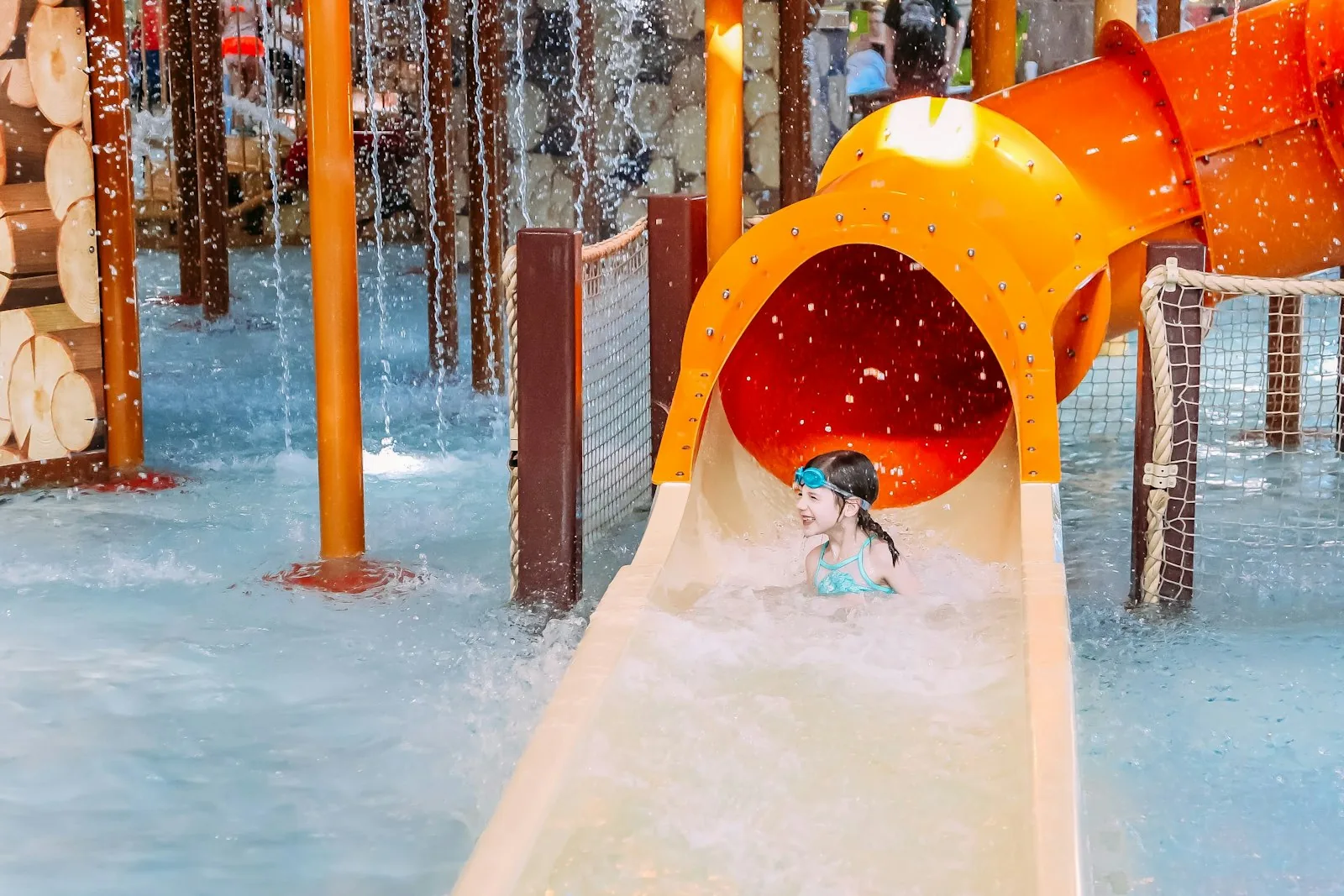 Children's indoor water park flumes and pool with colourful slides and splash features