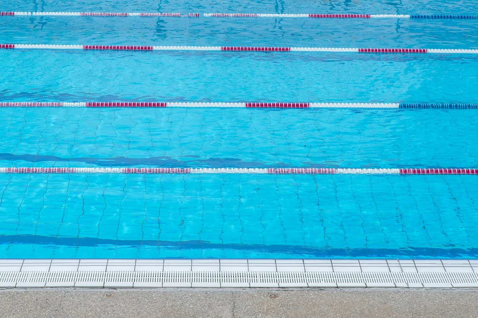 Outdoor public swimming pool with lane ropes