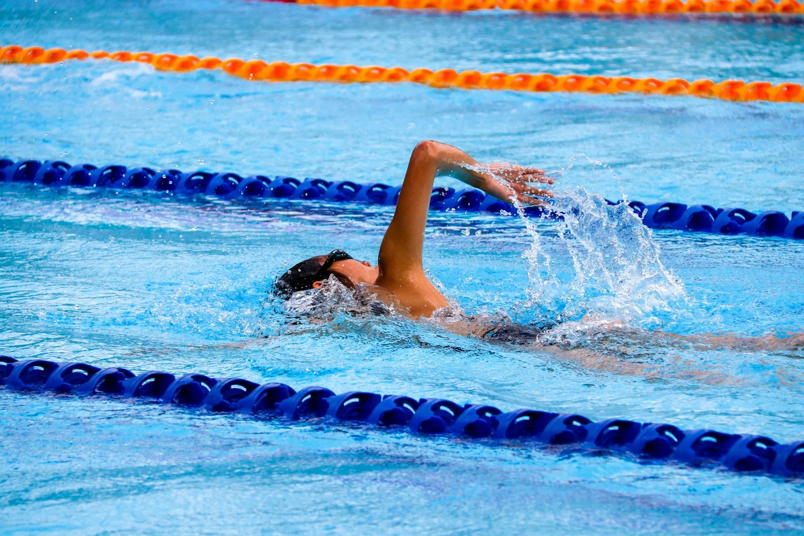 Backstroke swimmer in UK outdoor pool