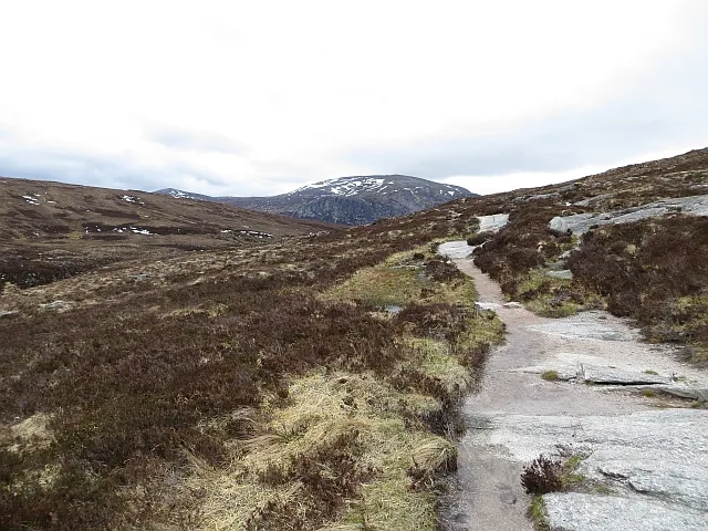 Rocky path through heather moorland in the Cairngorms leading to the Lairig Ghru