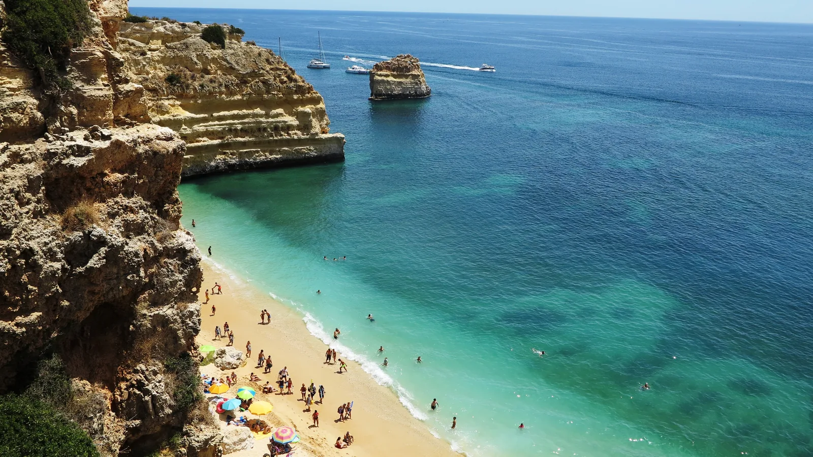 Praia de Marinha beach in the Algarve, Portugal, with golden limestone cliffs and clear turquoise water