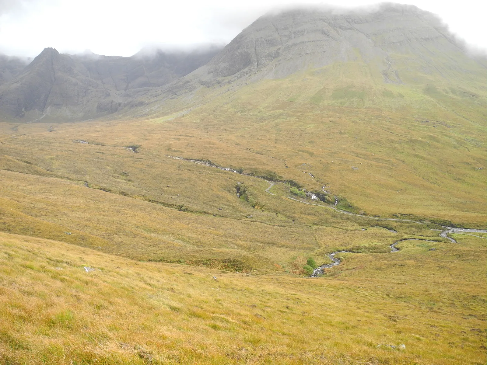 Wide view of Glen Brittle moorland showing the walk path and burn leading to the Fairy Pools with Cuillin mountains behind