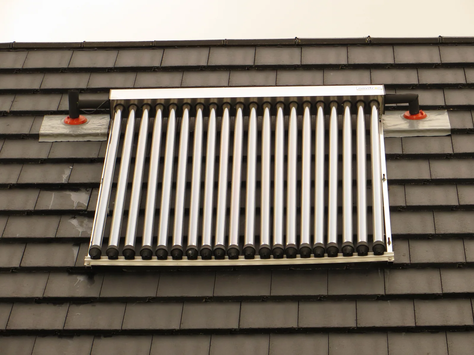 Evacuated tube solar thermal collector mounted on a tiled residential roof