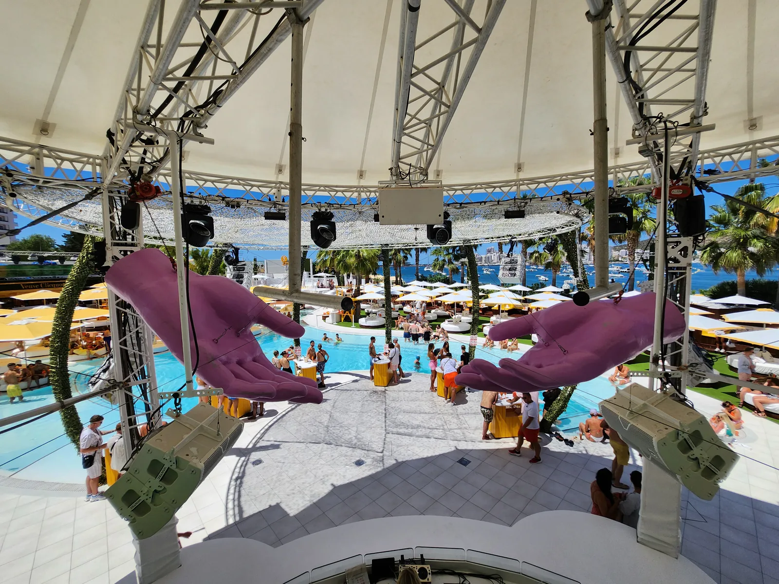O Beach Ibiza day club with large outdoor pool, sunbeds, palm trees and sea views – part of Ibiza's luxury holiday scene
