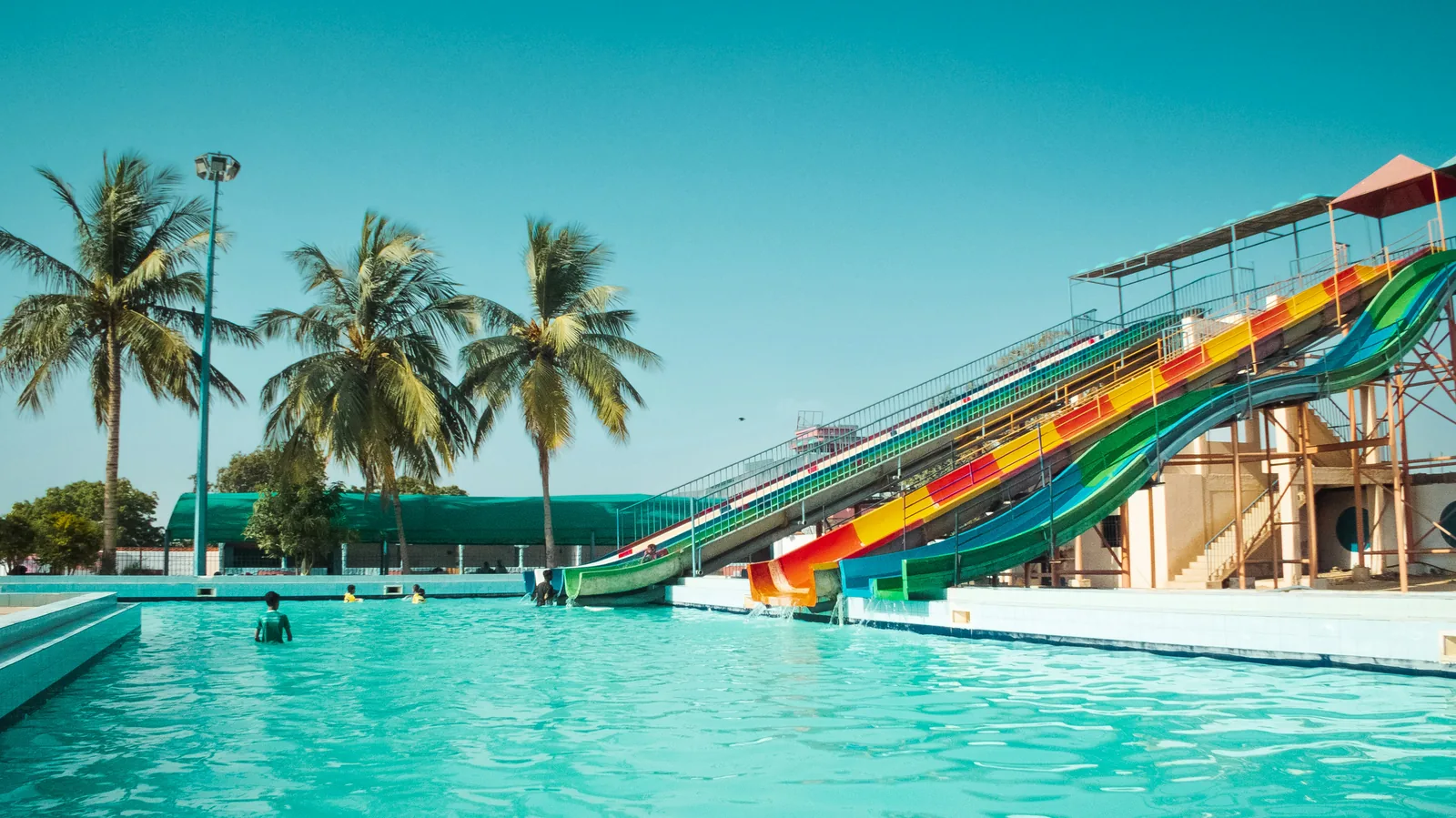 An indoor leisure pool with waterslides and wave machine in a family swimming centre