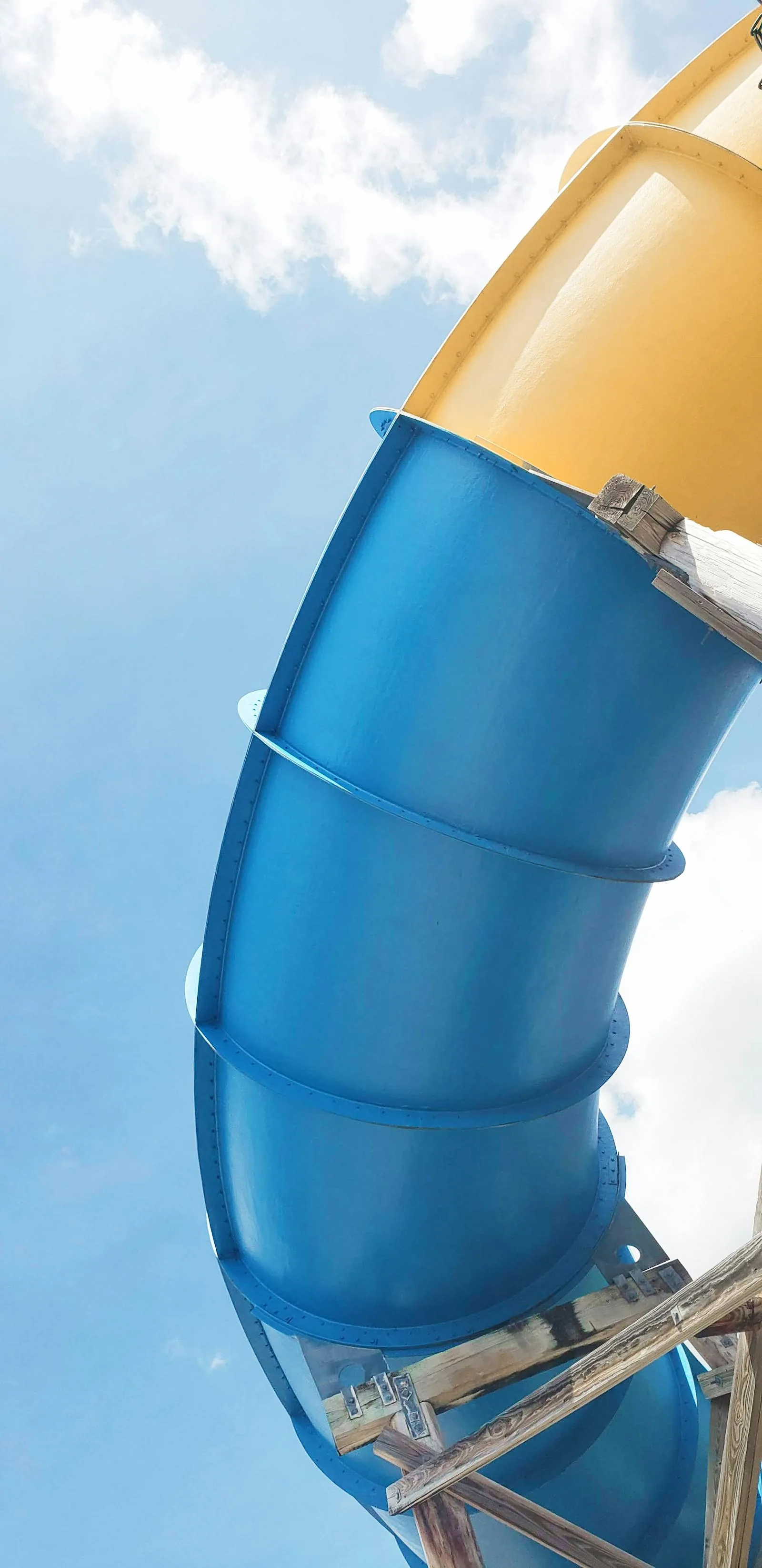 Water slide tubes against blue sky at a UK indoor water park or leisure centre with slides