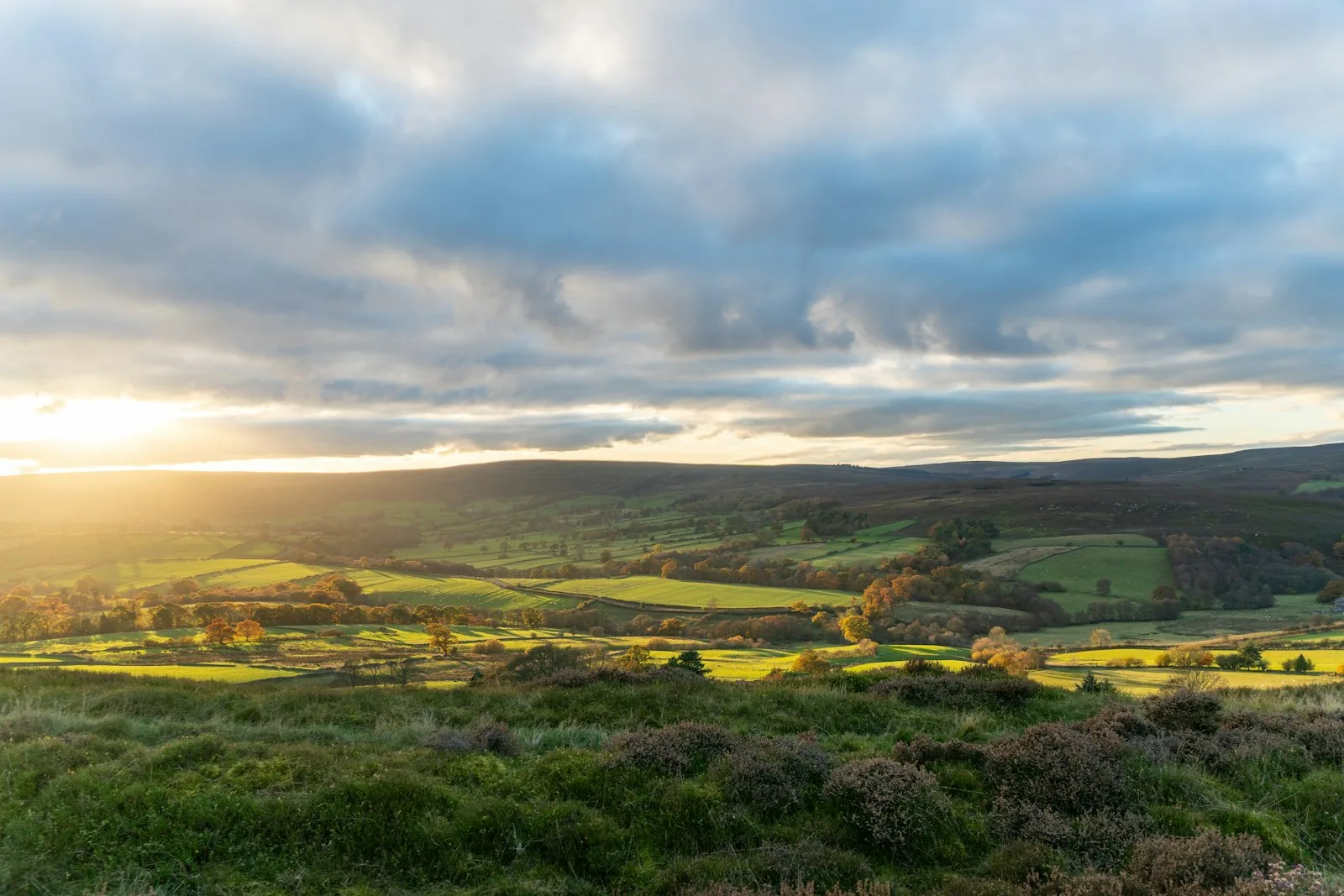 Remote upland lake in Wales with moorland and cloudy sky, reflecting the landscape