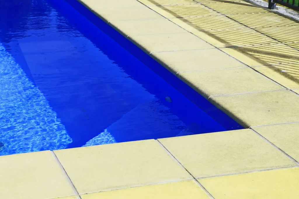 Deep blue outdoor swimming pool with vivid blue colour visible, demonstrating how pool depth affects the blue appearance of water